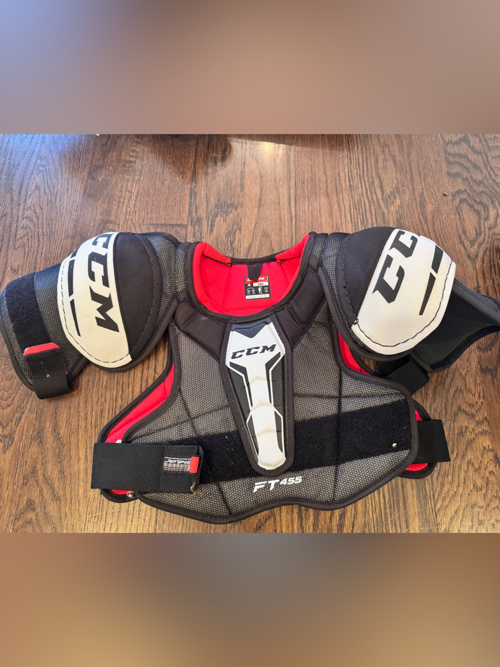 CCM Youth Hockey Shoulder Pads in Black, Red, and White
